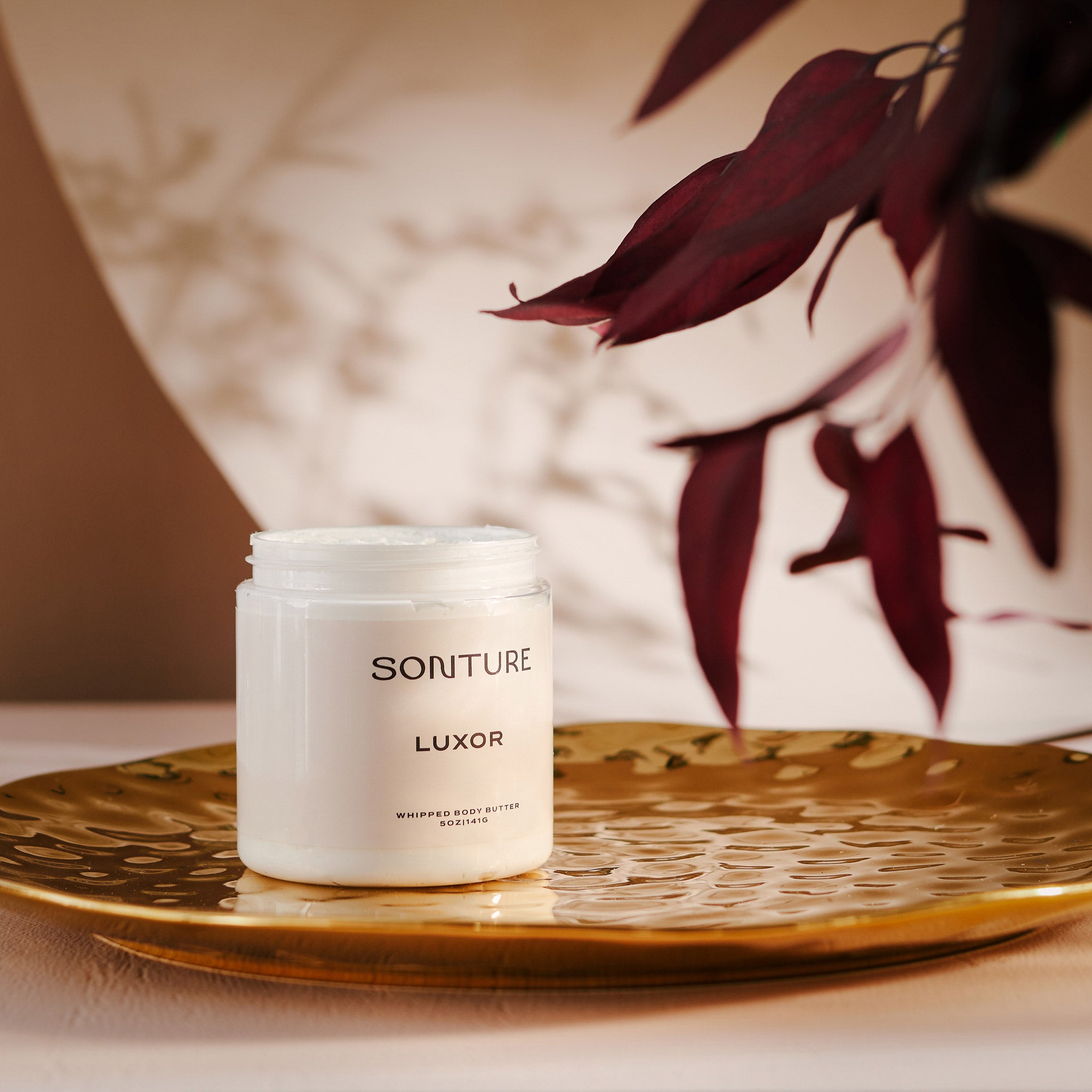 A collection of Sonture’s handmade, ethically created body care products inspired by travel. The products are styled on a gold tray and look high end, Luxurious and perfect for glamorous bathrooms.