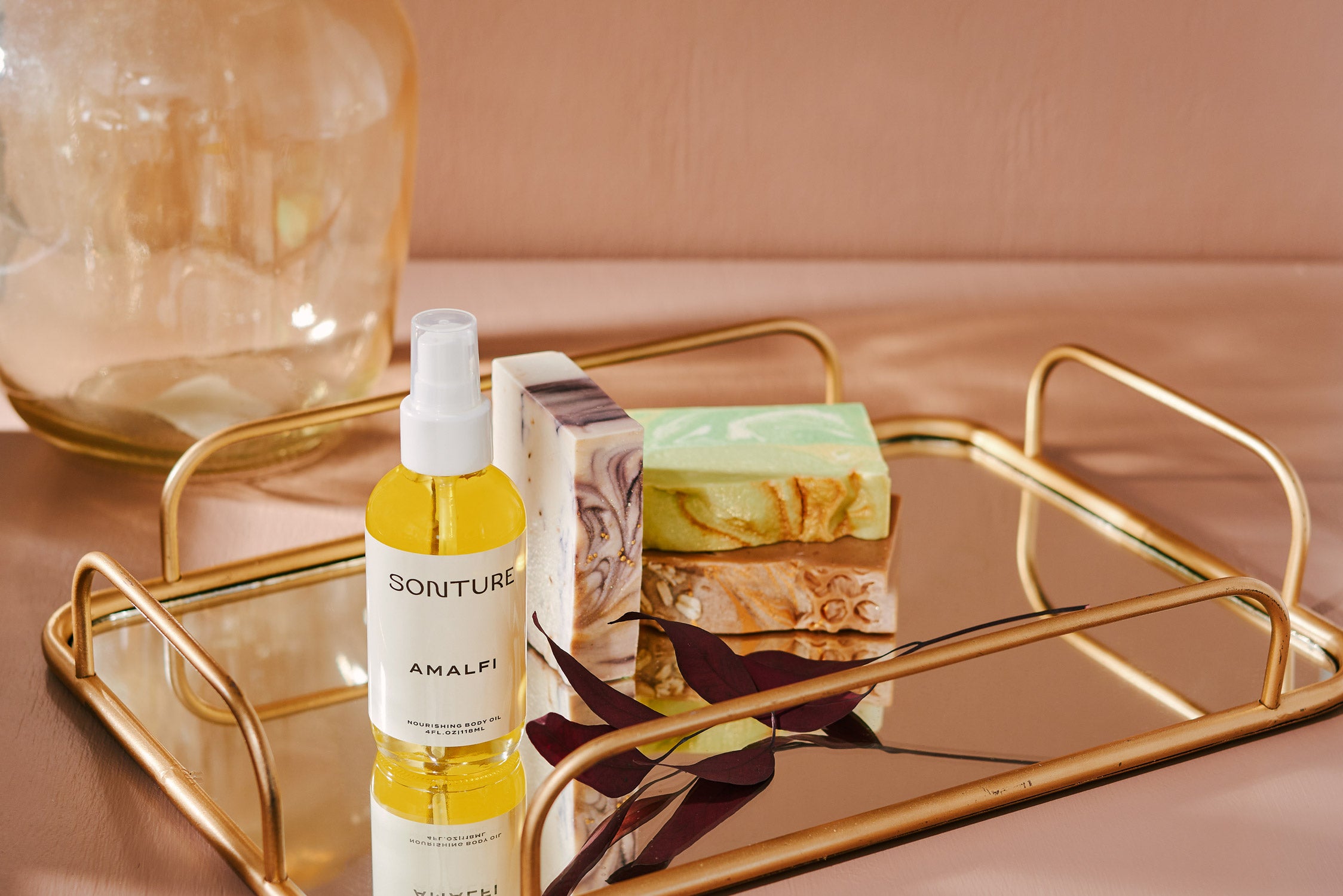 A collection of Sonture’s handmade, ethically created body care products inspired by travel. The products are styled on a gold tray and look high end, Luxurious and perfect for glamorous bathrooms.