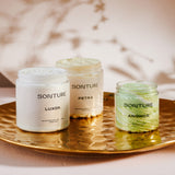 A collection of Sonture’s handmade, ethically created body care products inspired by travel. The products are styled on a gold tray and look high end, Luxurious and perfect for glamorous bathrooms.